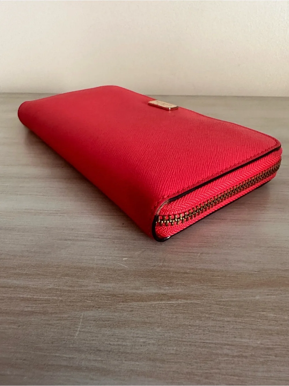 kate spade saffiano zip-around wallet in vibrant red with gold plaque